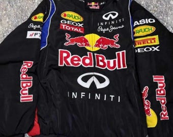 May include: Black Red Bull racing jacket with multiple sponsor logos. The jacket features the Red Bull logo prominently on the front and sleeves, along with Infiniti and Pepe Jeans branding. The jacket has a black base with red, white, yellow, and blue accents.