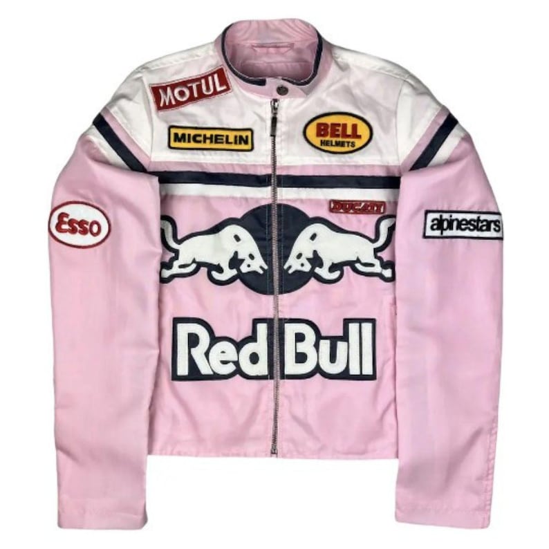 May include: Pink and white racing jacket with multiple sponsor patches, including "Motul," "Michelin," and "Bell Helmets." Features "Red Bull" logo and "Esso" patch. Black and navy blue stripes accent the design. A zippered front completes the look.