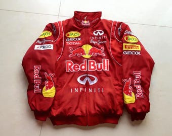 May include: Red jacket with multiple logos, including "Red Bull" and "Infiniti." The jacket is primarily red with white accents and features various sponsor logos. The jacket has a zipper closure and a stand-up collar.