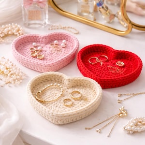 May include: A set of three ceramic mugs with a speckled, matte finish. The mugs are in shades of cream, light grey, and dark grey. Each mug has a simple, minimalist design, ideal for coffee or tea.