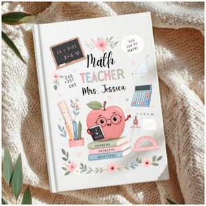 May include: A white hardcover notebook featuring the text Math Teacher Mrs. Jessica. The cover displays a pink apple character with glasses holding a book, surrounded by illustrations of a chalkboard, calculator, ruler, compass, and floral accents.
