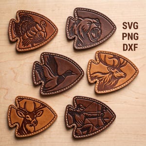 May include: Six arrowhead-shaped leather patches featuring embossed designs of a turkey, a bear, a duck, an elk, a deer, and an archer. Each patch has stitched edges and varying brown tones. The text SVG, PNG, and DXF is printed on the right.