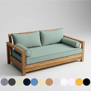 May include: A two-seater outdoor sofa with a natural wood frame and light green cushions. The cushions have black piping and include two square back cushions and two cylindrical bolster pillows. The sofa is designed for outdoor use.