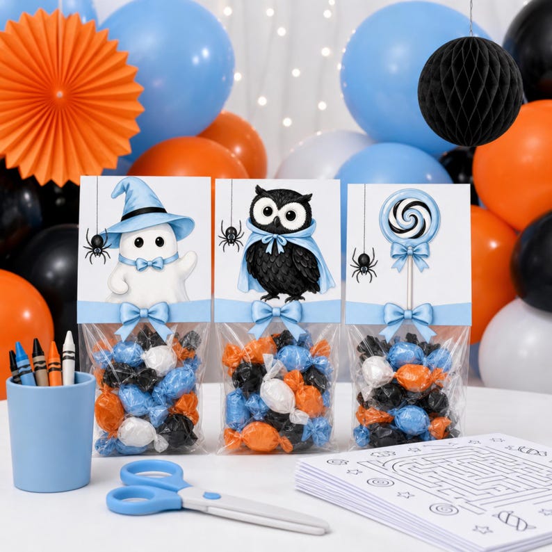Halloween treat-bag mockup featuring a witch ghost, blue-caped owl, and blue lollipop artwork with coordinating candy, balloons, craft supplies, and activity pages.
