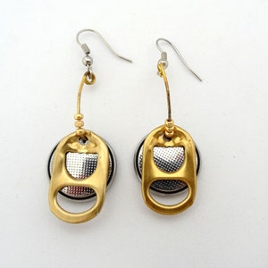 May include: A pair of gold earrings with silver pull tabs from a can. The earrings are hanging from silver hooks.