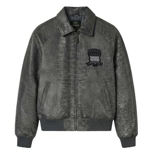 Puede incluir: Chaqueta de cuero gris con textura de piel de cocodrilo. La chaqueta tiene cuello, cierre de cremallera y un parche en el pecho. Los pu&ntilde;os y el dobladillo son acanalados. La chaqueta es talla mediana.