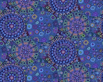 May include: A blue fabric with a repeating pattern of colorful circles. The circles are made up of smaller circles and dots in shades of blue, purple, pink, and green.