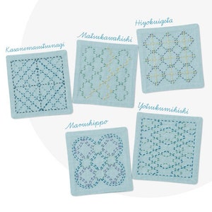 May include: Five blue fabric squares with different Japanese embroidery patterns. The squares are labeled with the names of the patterns in Japanese: Kasanemasttsunagi, Matsukawakishi, Hiyokugeta, Yotsukumimishi, and Marushippo.