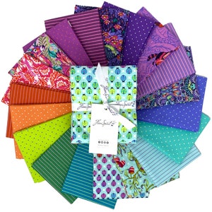 May include: A collection of 18 fabric squares in various colors and patterns, including stripes, polka dots, and floral designs. The fabric squares are arranged in a fan shape, with a white box in the center that says "Free Spirit".