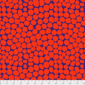 May include: A fabric with a repeating pattern of orange, irregularly shaped circles against a deep blue background. The design is reminiscent of a pebble or stone pattern, creating a textured visual effect. The fabric is measured in inches.