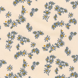 May include: A white fabric with a repeating pattern of blue daisy flowers. The flowers are arranged in clusters and are scattered randomly across the fabric.