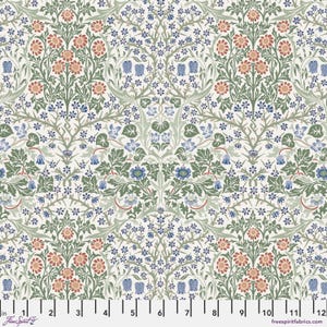 May include: A white fabric with a repeating pattern of blue, green, and orange flowers. The pattern is reminiscent of a traditional floral design.