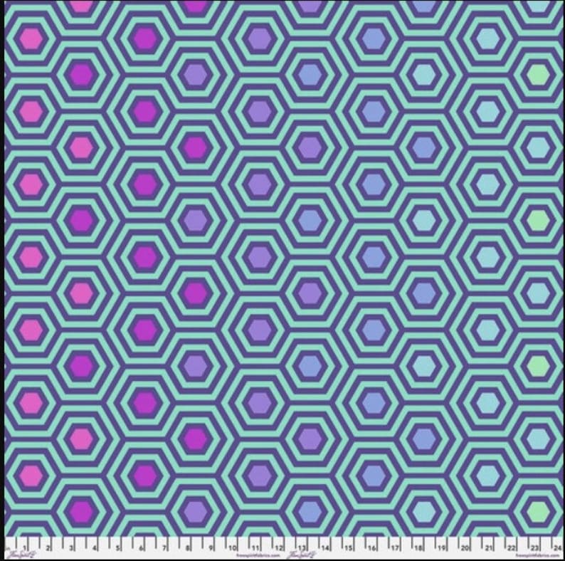 May include: A repeating pattern of blue, purple, and pink hexagons on a light blue background. The hexagons are outlined in dark blue.