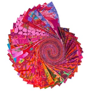 May include: A spiral of colorful fabric swatches in shades of pink, red, orange, and purple. The fabric has various floral and geometric patterns. The swatches are arranged in a circular pattern, with the edges fanning out from the center.