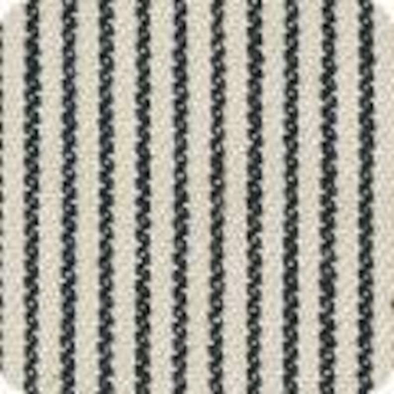 Puede incluir: Primer plano de una muestra de tela con un patr&oacute;n de rayas verticales. Las rayas son de color azul marino oscuro sobre un fondo crema. La tela parece tener una textura tejida, lo que sugiere que podr&iacute;a usarse para tapicer&iacute;a o decoraci&oacute;n del hogar.