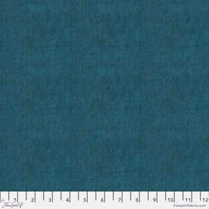 May include: Teal fabric with a textured appearance. The fabric has a woven pattern and a dark teal color. The image includes a ruler with inch measurements and the text "Free Spirit" and "freespiritfabrics.com".