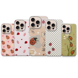 May include: Five phone cases with various designs featuring ladybugs. The cases have different backgrounds, including pink with flowers, white with hearts, beige with a ladybug and a teacup, white with black polka dots, and green with a flower.