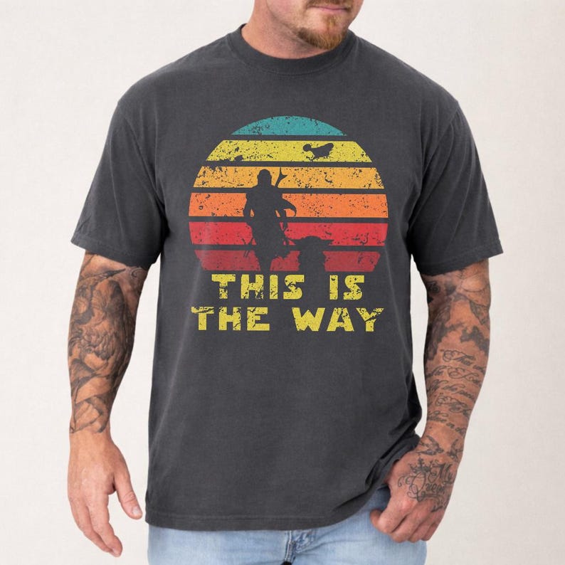 Vintage distressed retro sunset graphic featuring a galactic warrior silhouette with the quote “This Is The Way” on a dark t-shirt design in bootleg vintage style.