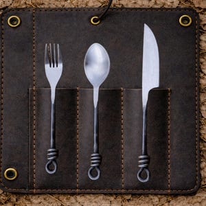 May include: A dark brown leather cutlery roll with a fork, spoon, and knife. The stainless steel utensils have dark metal handles with a looped design. The roll has brass eyelets and a leather tie closure, perfect for camping or outdoor dining.