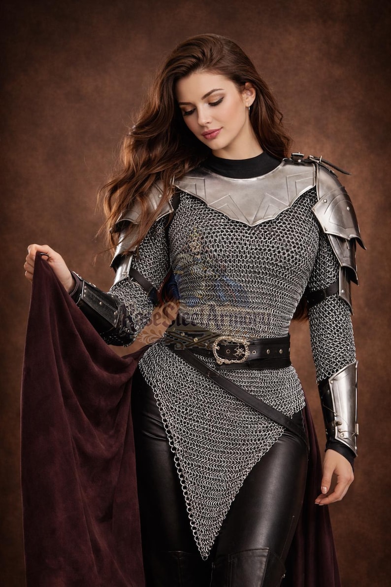 May include: A medieval-style ensemble featuring chainmail, metal shoulder armor, and black leather pants. The outfit includes a black belt with a decorative buckle and a dark red cape. The image has the text "ese Steel Armoury".