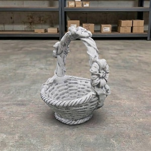 May include: A gray, weathered-look concrete basket featuring a woven texture on the bowl and a handle adorned with sculpted floral details. The surface has a distressed finish with lighter highlights, giving it a stone-like appearance throughout.