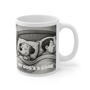 May include: White ceramic mug with a black and white illustration of a person and a dog sleeping in a bed. The text "MY DOG'S A KNOB!" is printed below the illustration.
