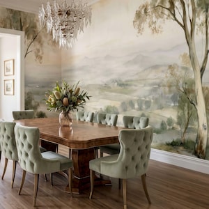 May include: A dining room featuring a large wooden table with a polished finish, surrounded by eight sage green tufted velvet chairs. A glass chandelier hangs above a floral centrepiece, set against a wall mural of a landscape with trees.