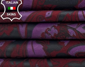 May include: A stack of patterned fabric with a paisley design in shades of burgundy, purple, and black. The fabric is folded and stacked, revealing the intricate pattern. The image includes the text "ITALIAN SKINS".