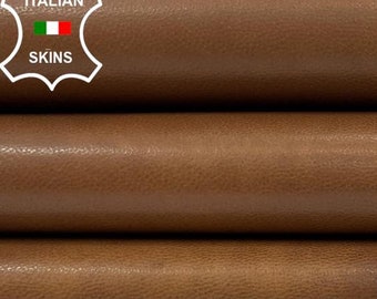 May include: Close-up of a stack of brown leather hides. The leather is smooth and has a slight sheen. The hides are folded in thirds and are stacked on top of each other. The leather is labelled "ITALIAN SKINS".