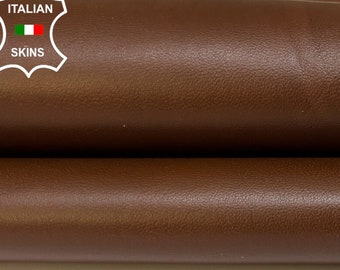 May include: Close-up of two rolls of brown leather. The leather is smooth and has a slight sheen. The label "ITALIAN SKINS" is visible in the top left corner.