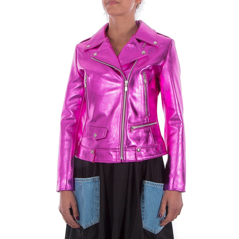 May include: A pink metallic leather jacket with a zipper closure and multiple pockets.