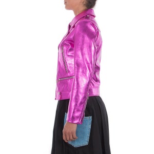 May include: A pink metallic leather jacket with a zipper closure and a stand-up collar.