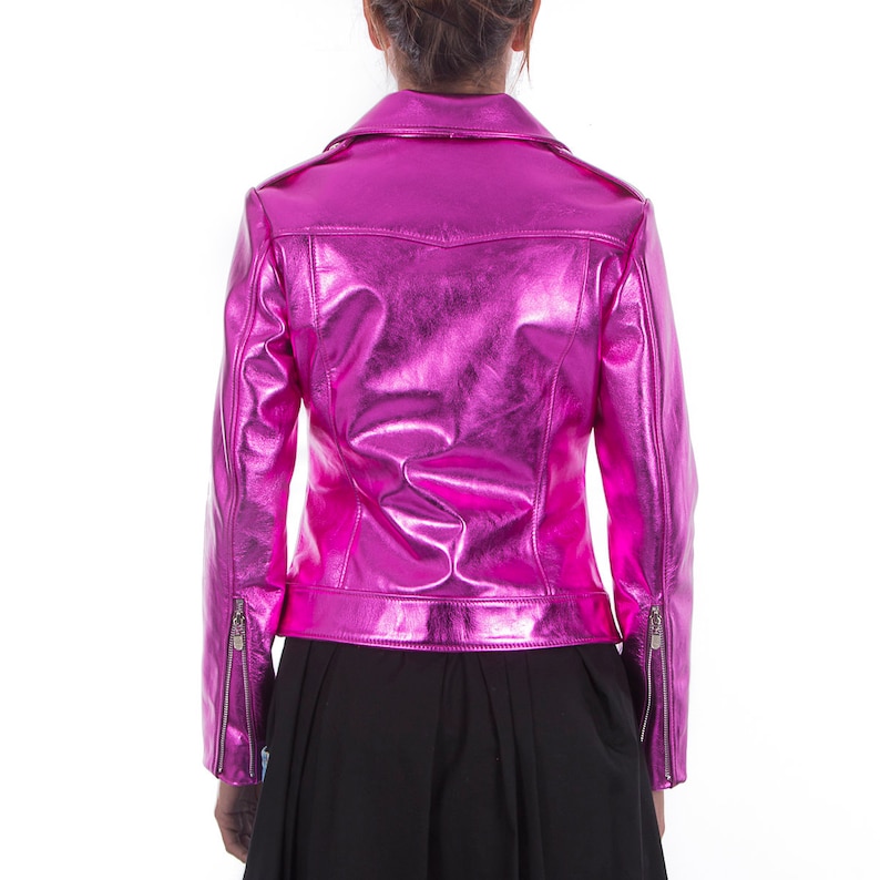 May include: A pink metallic leather jacket with a zipper closure. The jacket has a stand-up collar and long sleeves.