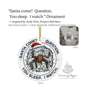 May include: A round white ceramic ornament featuring a brown, multi-legged creature inside a geometric wire frame wrapped in colourful Christmas lights. The creature wears a red Santa hat. The text reads: SANTA COME? QUESTION. YOU SLEEP. I WATCH.