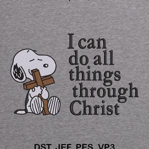 May include: A gray background features a Snoopy character holding a cross, with the text "I can do all things through Christ." The image also includes the text "2 sizes | 5x7, 6x10" and "DST, JEF, PES, VP3."