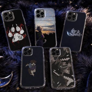May include: Five clear phone cases with distinct graphic designs: a white paw print with red accents, a person looking at a sunset, a small white creature using a laptop, a person hugging a dog, and a dark camouflage pattern with jagged shapes.