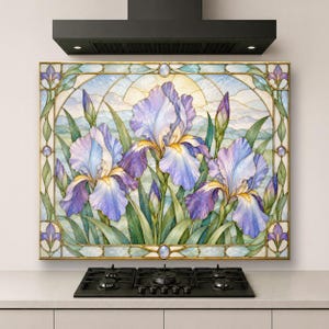 May include: A rectangular wall panel featuring a stained glass style illustration of three large purple and blue iris flowers with green leaves. The design is framed by a decorative border with small circular accents and a pale sky background.