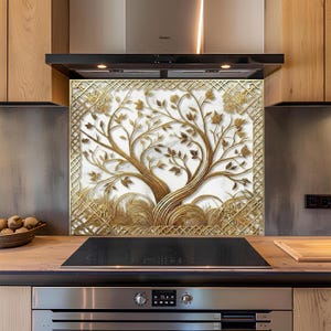 May include: A gold-coloured kitchen splashback with a detailed tree design. The tree features textured leaves and branches set against a white backdrop. The splashback is framed with a gold lattice pattern, adding a decorative touch.