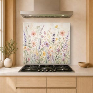 May include: A rectangular wall art panel featuring a watercolour-style illustration of a wildflower meadow. The design displays various stems, leaves, and blossoms in soft shades of pink, purple, yellow, and green against a cream-coloured background.