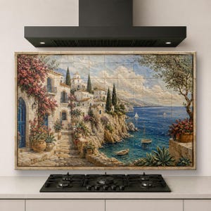 May include: A rectangular wall mural composed of square tiles depicting a coastal Mediterranean village scene with white stone buildings, pink flowering vines, a blue sea, sailboats, and rocky cliffs, installed above a black kitchen stove.