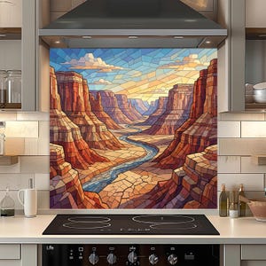 May include: A kitchen splashback with a stained-glass effect, showing a canyon scene. The artwork features red and brown rock formations, a winding river, and a blue sky with clouds. The splashback is above a black hob.