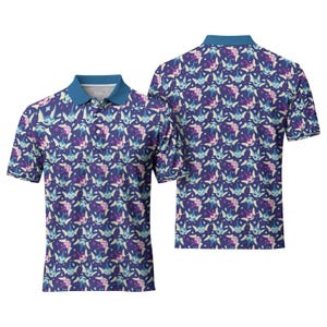 May include: Two polo shirts with a repeating pattern of cartoon characters in shades of blue, purple, and cream on a navy blue background. The shirts have a blue collar and short sleeves. One shirt is shown from the front, the other from the back.