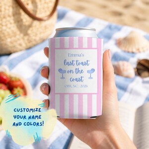 May include: A pink and white vertical striped foam can cooler featuring a white rectangular centre panel with the blue text Emma's last toast on the coast, two blue margarita glass illustrations, and the text OBX, NC 2026 at the bottom.