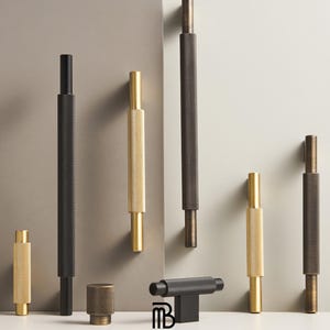 May include: A white ceramic mug with a black handle and the text "But First, Coffee" in a bold, black font. The mug is set against a blurred background, suggesting a cosy setting.