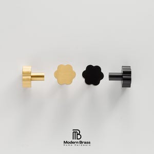 A solid brass round drawer knob with a matching antique brass finish for a cohesive furniture look.