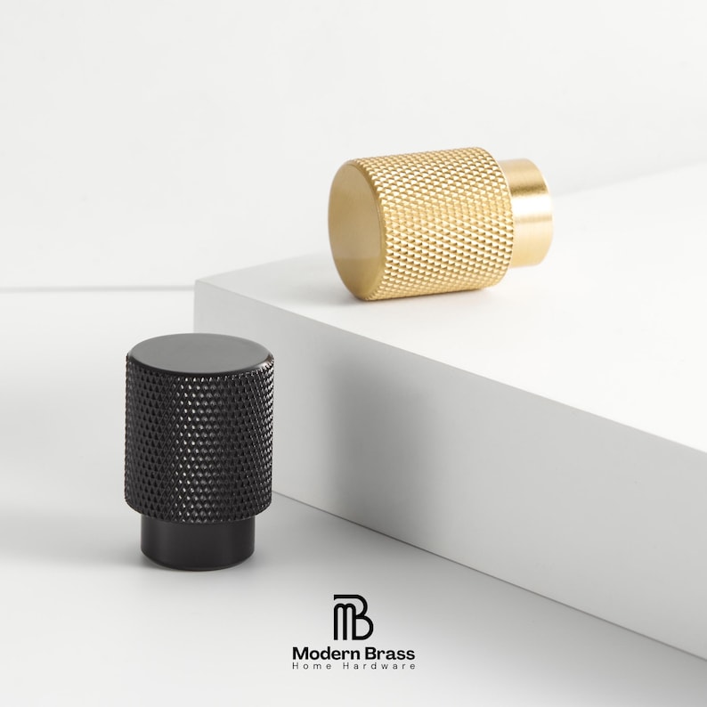 Textured brass drawer pulls featuring a diamond-cut grip and sleek square mounting bases.