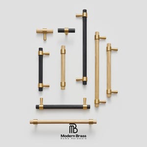 Modern fluted brass knobs in cylindrical shapes with brushed gold and silver metallic textures.