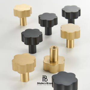 Solid brass knurled knobs and matching pulls for a cohesive luxury cabinetry restoration project.
