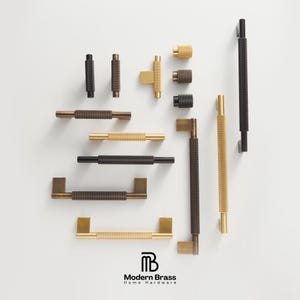 Close-up of solid brass hexagonal knobs displayed on mounting stems with a warm satin texture.