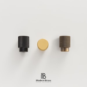 Fingerprint-resistant brushed gold handles and knobs ideal for heavy-use kitchen pantries.